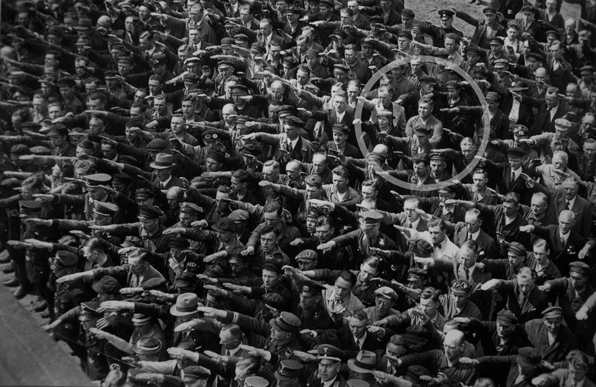 A lone man refusing to do the Sieg Heil salute at the launching of the Horst Wessell in Nazi Germany, 1936