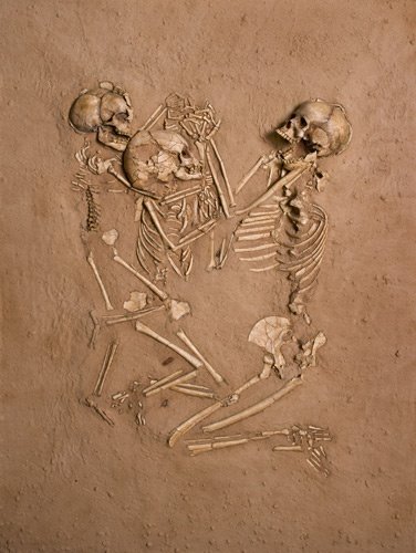 A woman and her 2 children die within 24 hours of each other and are buried on a bed of flowers.. 5000 years later they are found, still holding hands.