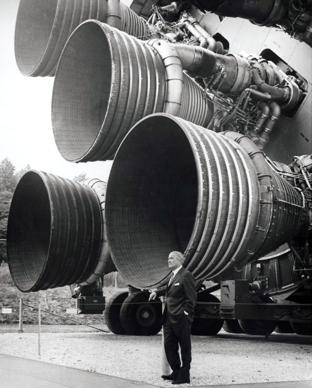 Dr. von Braun stands by the five F-1 engines of the Saturn V