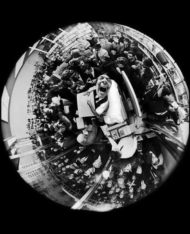 Salvador Dali at a book signing, taken with a fisheye lens, by Philippe Halsman, 1963