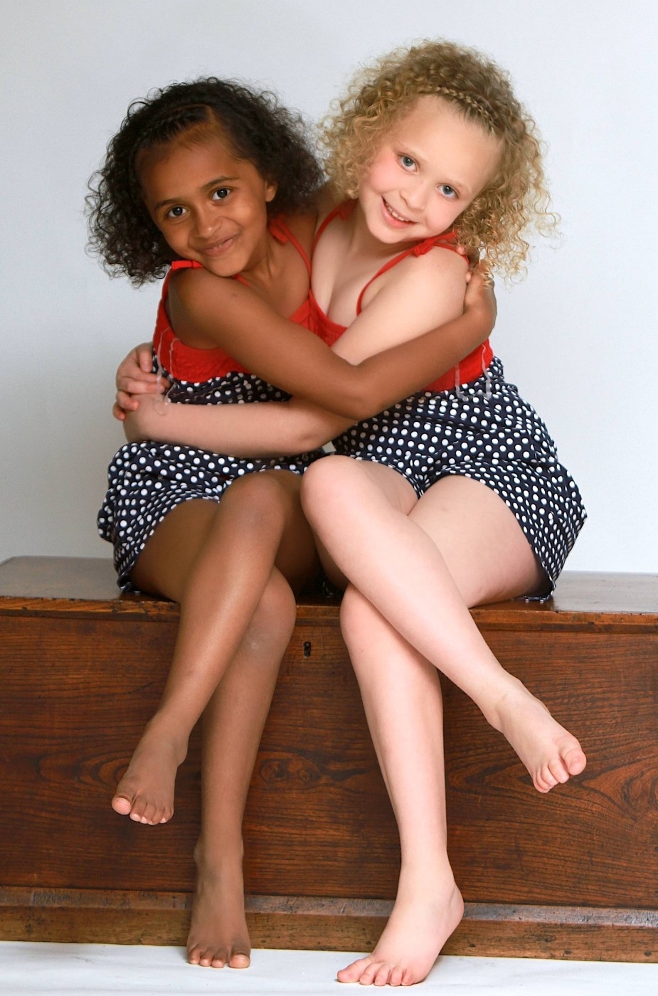 Twins Kian and Remee. Born a minute apart  one black, one white, due to the rare combination of their parents genes, both parents have a white mother and a black father. They have just turned 7.