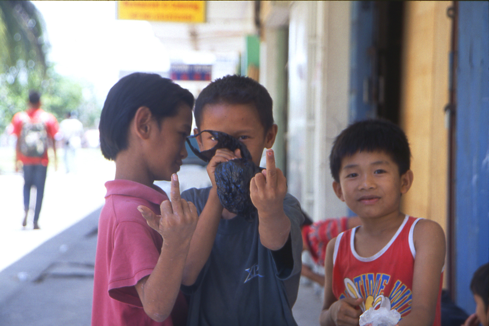 Homeless children in Borneo sniffing glue