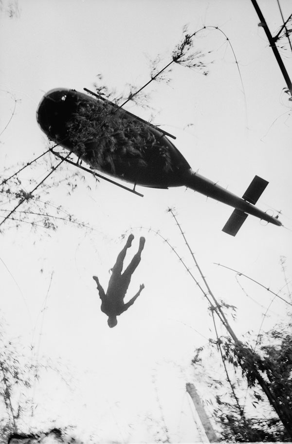 Fallen soldier being raised to helicopter in Vietnam War 1966