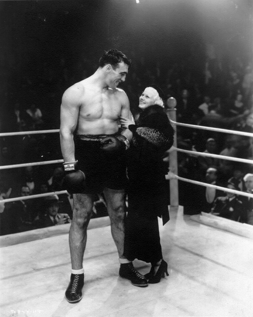 Actress Jean Harlow poses with boxer Primo Carnera, 1933