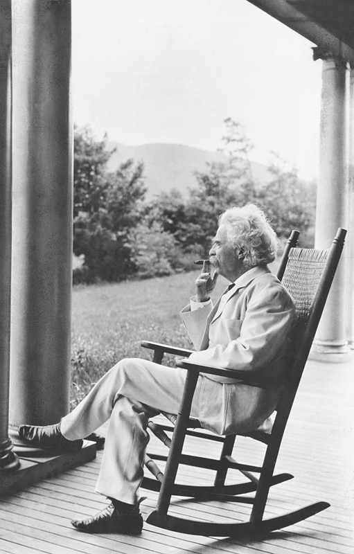 Mark Twain smoking a cigar and relaxing on the porch, 1905