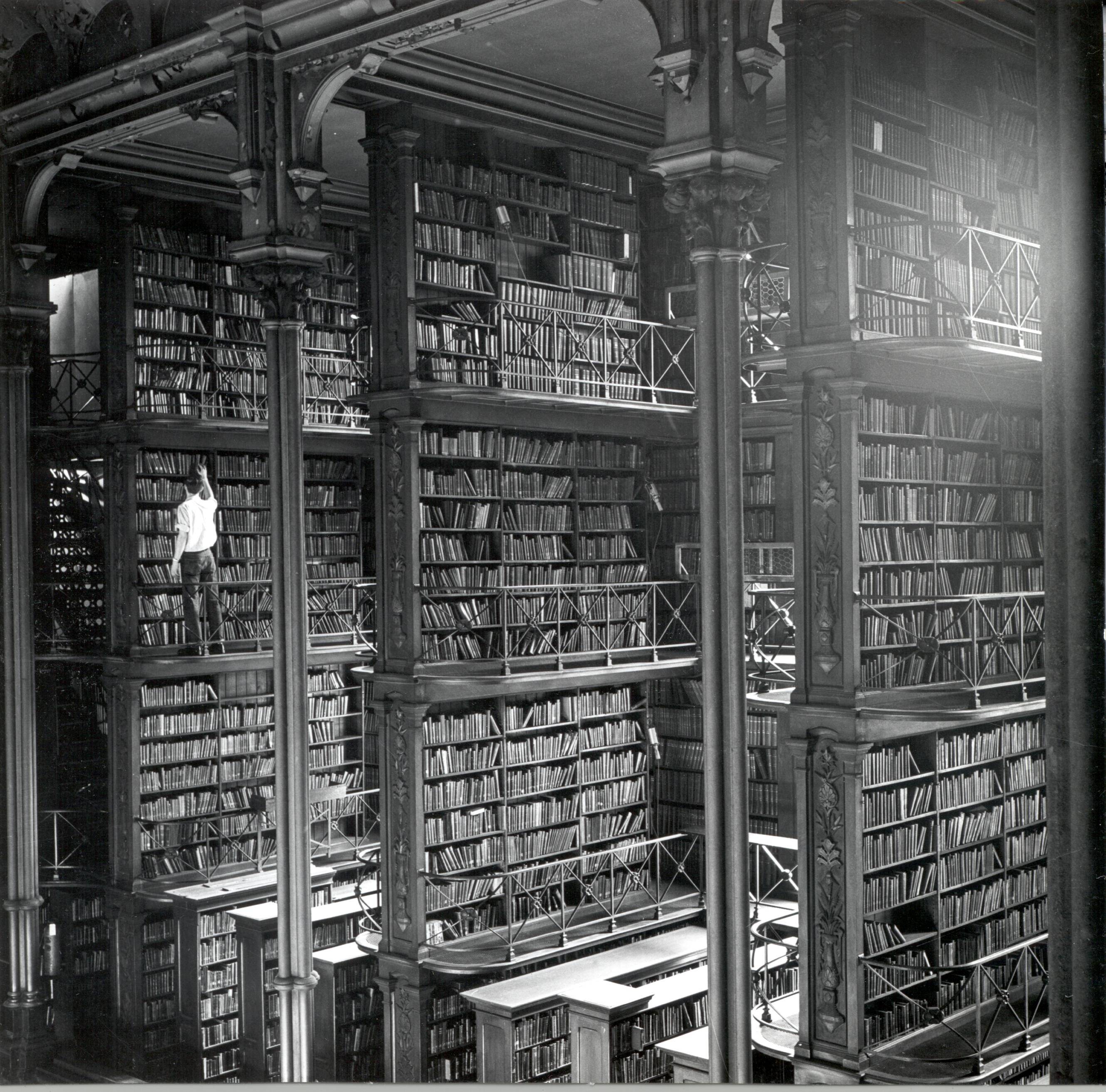A man browsing for books in Cincinnati's cavernous old main library. The library was demolished in 1955