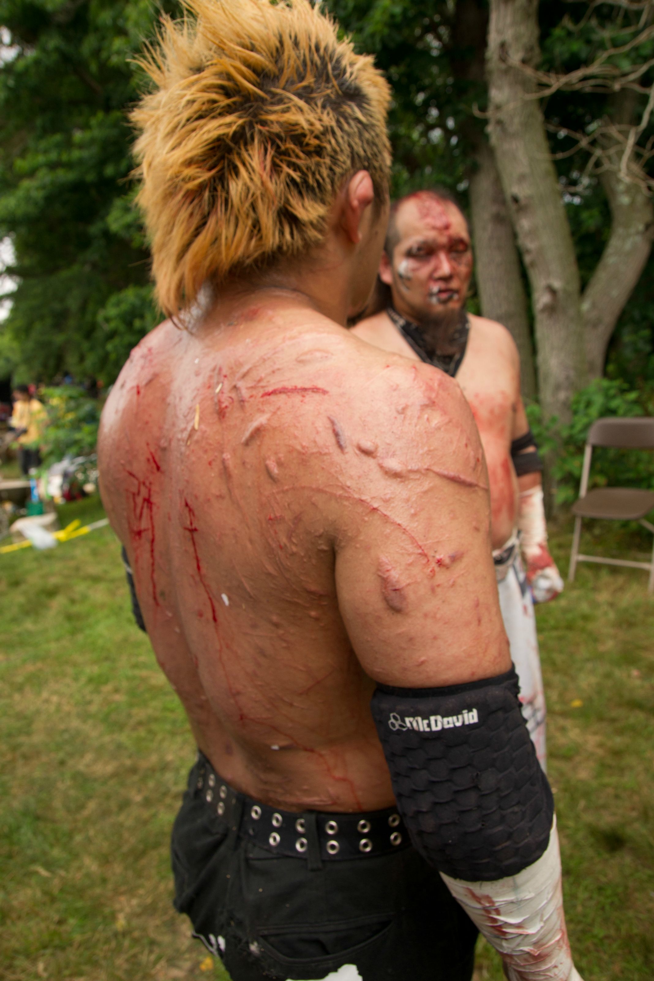 The scarred up back of a Japanese Death Match wrestler
