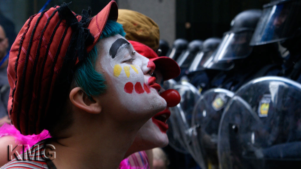 Protesters dressed as clowns entertain guards at a G20 meeting. Toronto, Canada, 2010