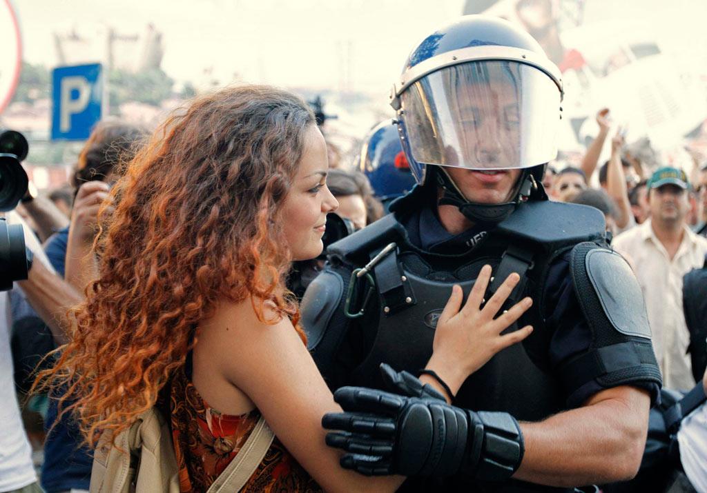 Young protester embraces police officer. Lisbon, Portugal, 2012
