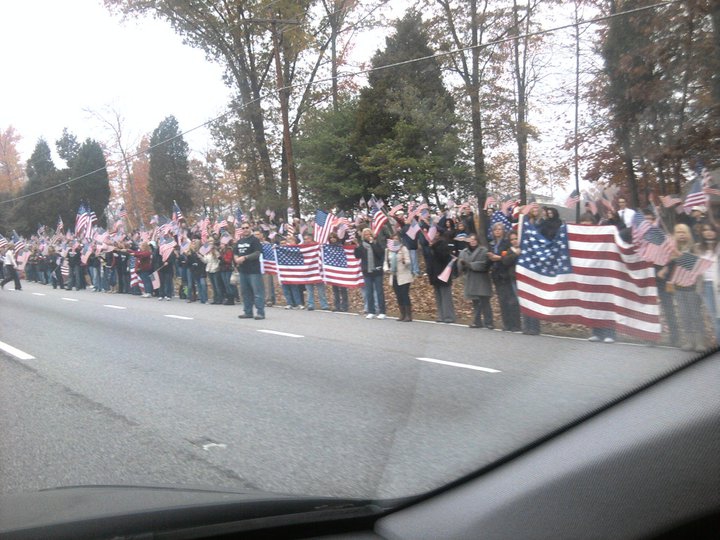Mourners form a 5-mile barrier between a soldier's funeral and the Westboro Baptist Church. USA, 2012