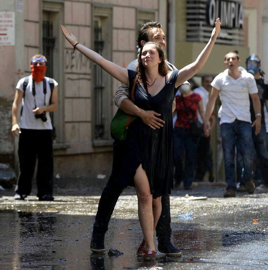 A Turkish couple moments after being doused by water cannons. Ankara, Turkey, 2013