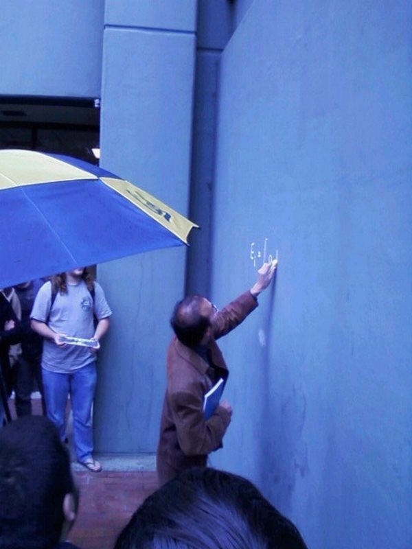 Berkeley professor teaches his class on the side of a building after an evacuation following protest. University of California, USA, 2011