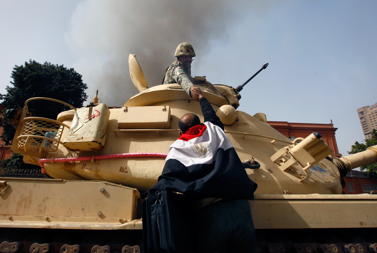 Egyptians embrace army soldiers after they refuse orders to fire on civilians. Cairo, Egypt, 2011