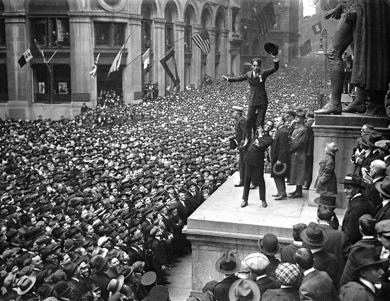 Charlie Chaplin being held in the air by Douglas Fairbanks, 1918