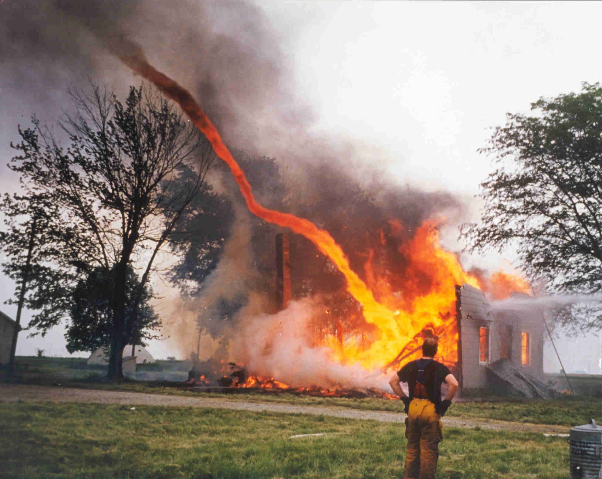 Fire from a burning bulding being sucked into a tornado