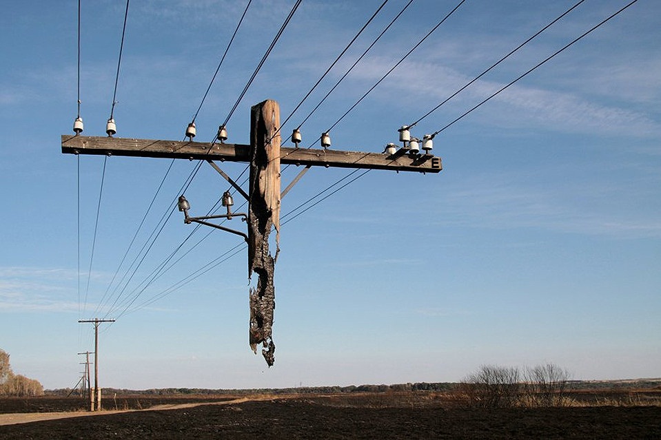 Electric pole hanging after a wild fire