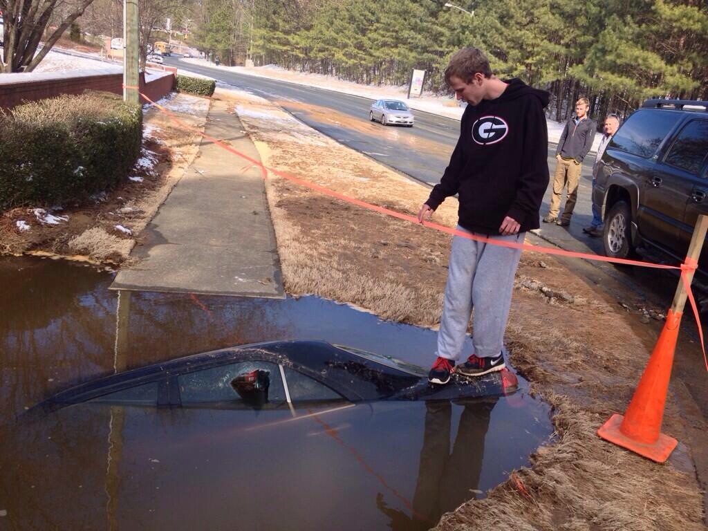 Georgia teen standing on top of his car pre excavation. January 30, 2014