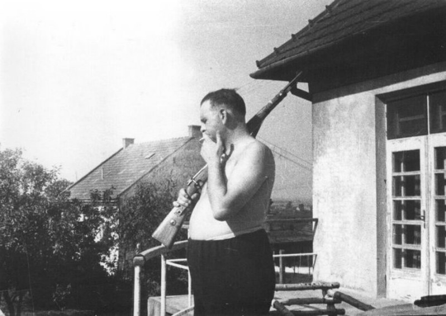 Camp Commandant Amon Goeth, infamous from the movie "Schindlers List", on the balcony of his house overlooking Plaszow labor camp, Poland . 1943-44.