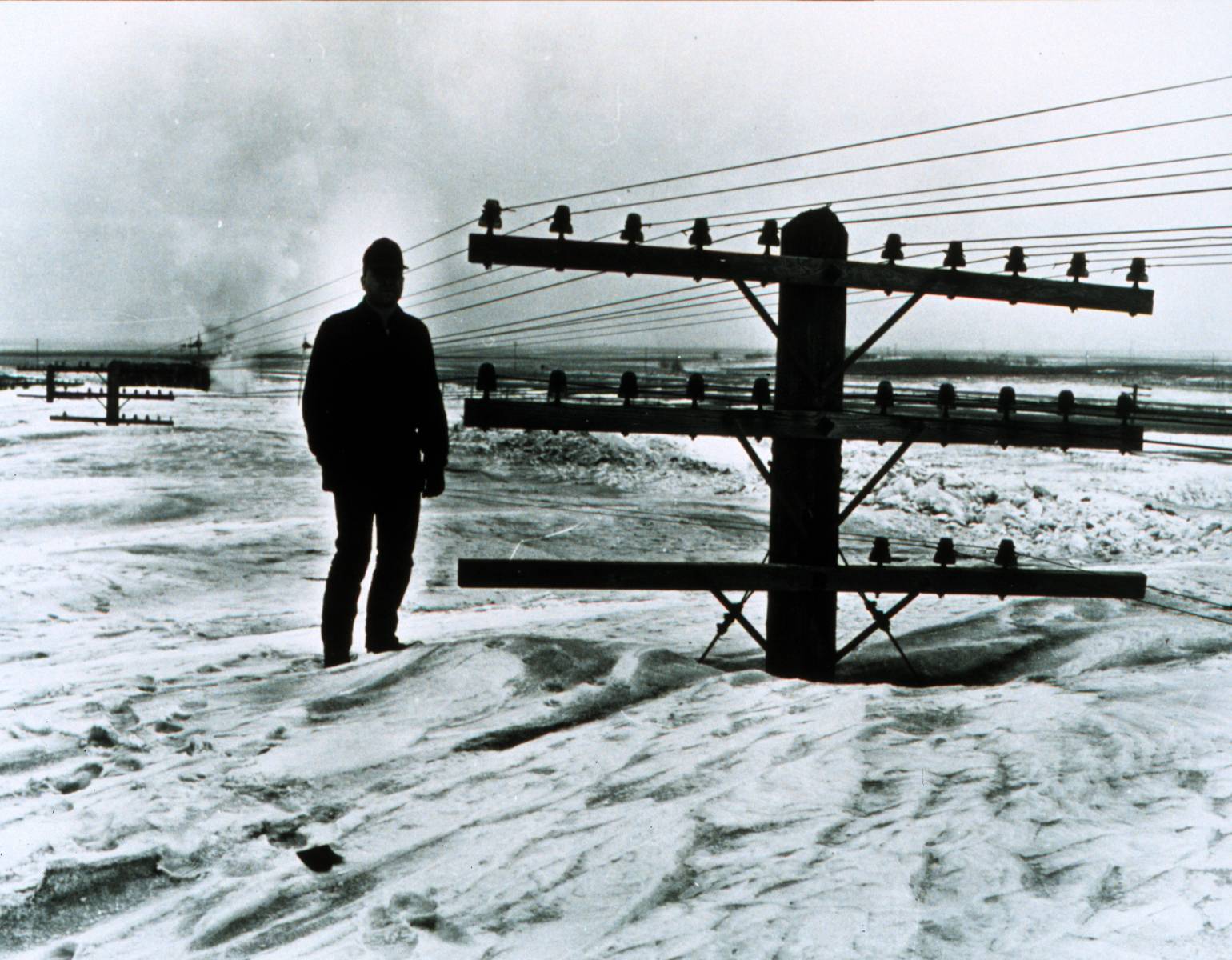 March blizzard in North Dakota, 1966. Caption jokingly reads "I believe there is a train under here somewhere!"