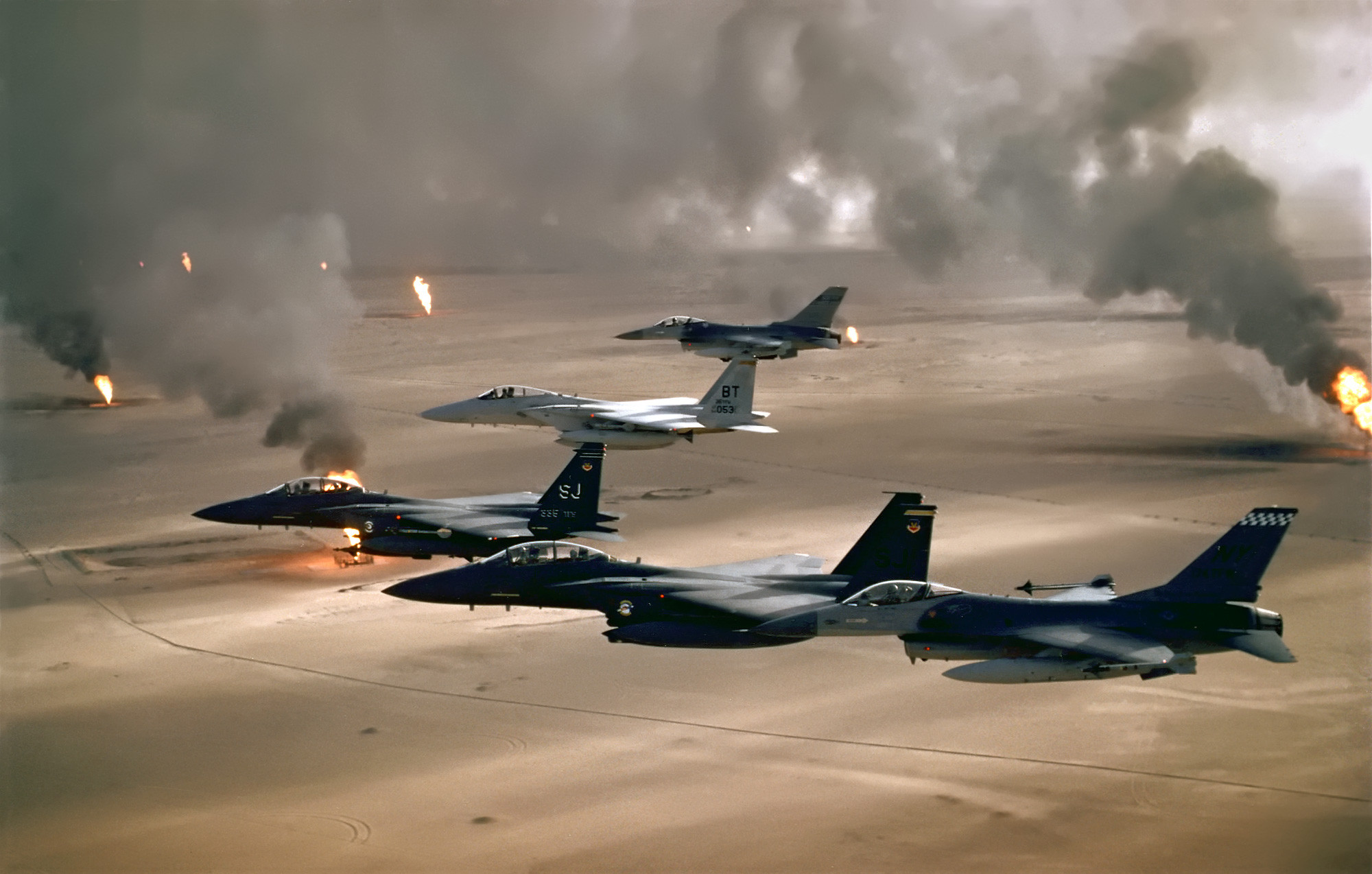 USAF aircraft fly over burning Kuwaiti oil wells, 1991