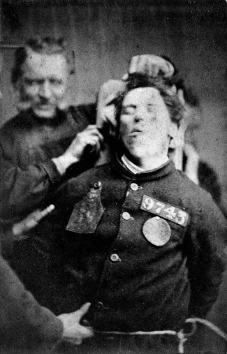 An insane asylum patient restrained by warders, Yorkshire, 1869, Henry Clarke.