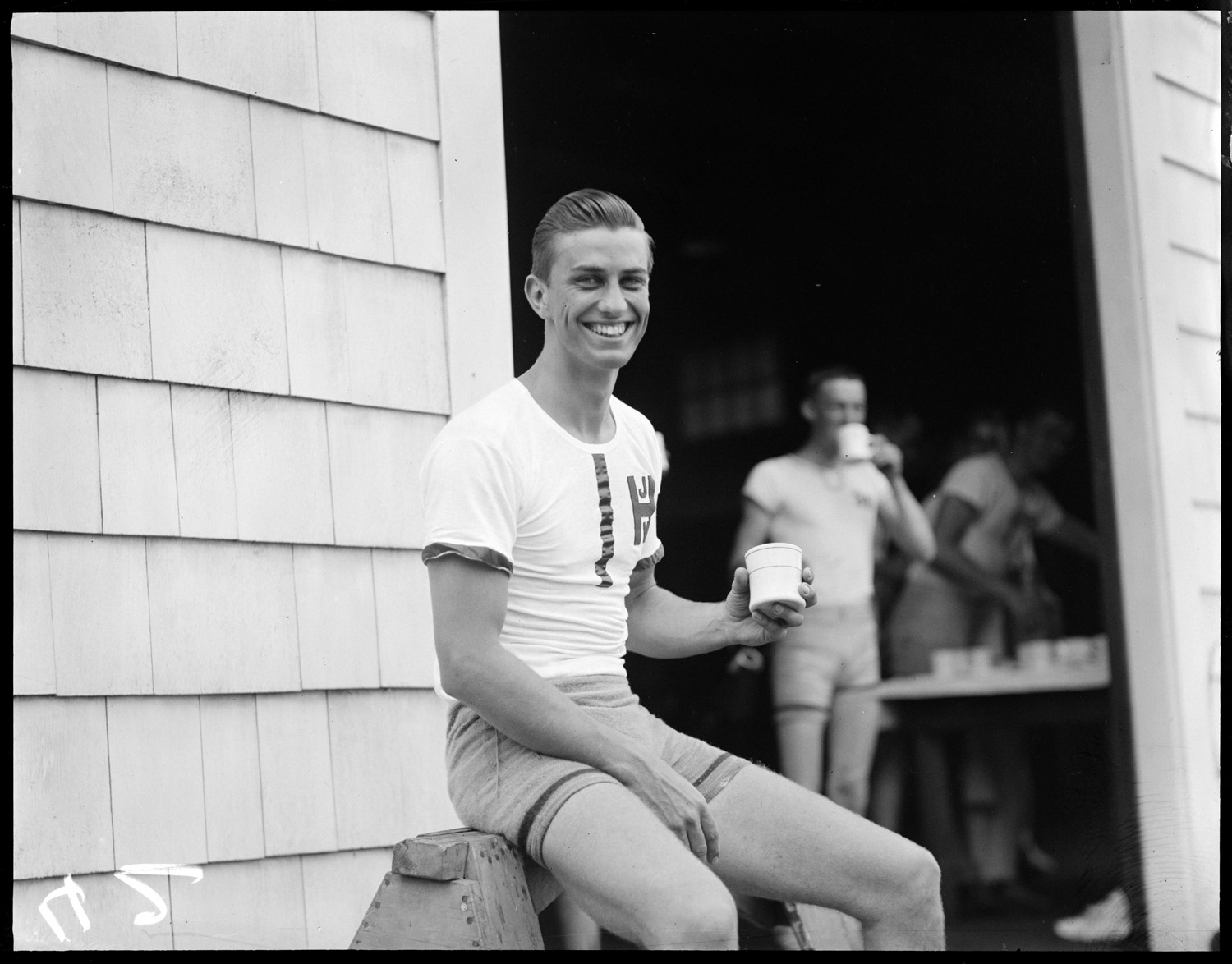 Franklin D. Roosevelt Jr. taking a break after rowing with Harvard crew