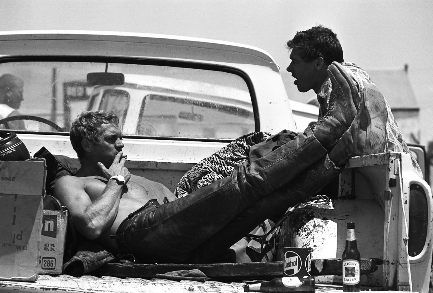 Steve McQueen kicking back after participated in a 500-mile, two-day dirt bike race across the Mojave Desert, 1963