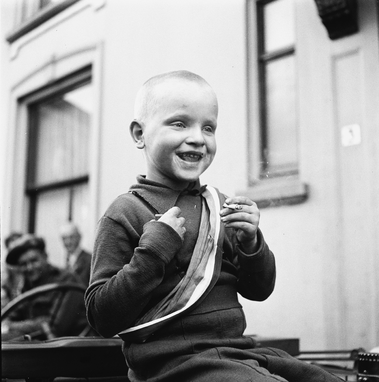 A young boy celebrates the liberation of the Netherlands by Allied Forces with a cigarette, 1945