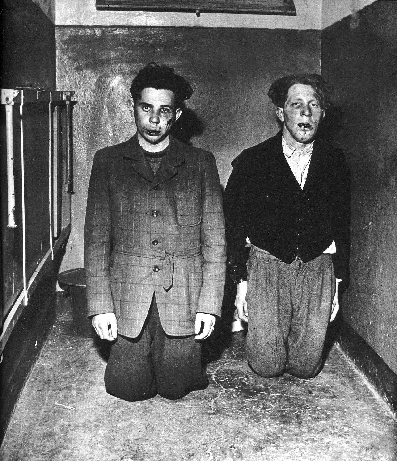 Prisoners beat two guards after their concentration camp is liberated by US forces