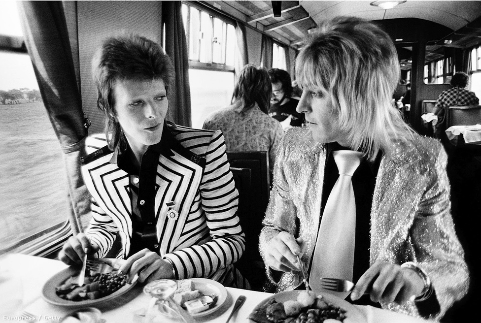 David Bowie and Mick Ronson enjoy lunch on the train in 1973