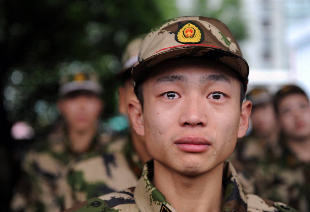 A Chinese paramilitary police recruit being shipped to start his service in the Zhejiang province began to tear up in this photo, taken on Dec. 12, 2010.