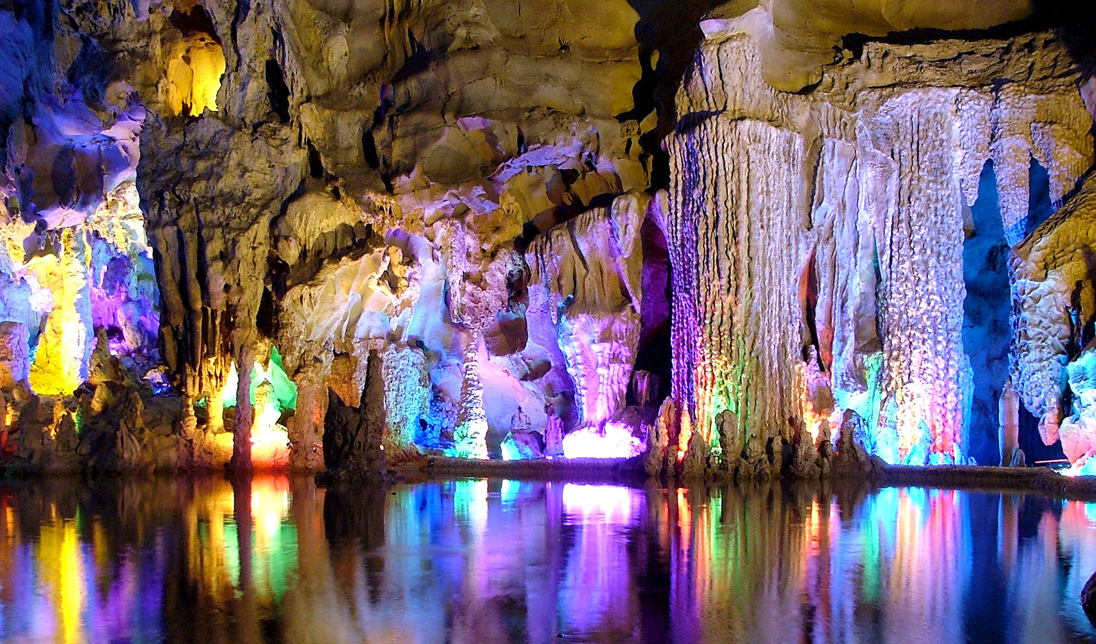 Reed Flute Cave China- The Reed Flute cave has been a popular destination for well over a thousand years, as evidenced by transcriptions inside that date back to 792 AD. It was named for the reeds that grow just outside the entrance, which can be made into flutes. The formations inside the cave are just incredible, and combined with all the surreal lighting, they prove that amazing things can happen when man and nature's efforts combine.