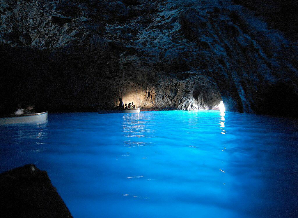 Grotto Azzurra Italy- If you're ever near Capri, Italy, you NEED to take a trip to the Blue Grotto. Once thought to be inhabited by sirens and devils, the cave is known for its radiant blue water. When the sunlight enters the cave through an underwater entrance, the water filters out the red light and leaves only the blue light to illuminate the cavern.