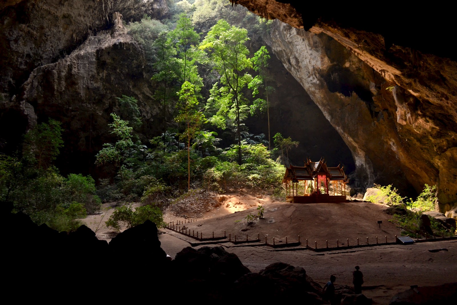 Phraya Nakhon Cave Thailand- Inside the Khao Sam Roi Yot National Park is the Phraya Nakhon: an incredible cave with an interesting history behind it. Sunlight filters through the top of the structure's collapsed ceiling, illuminating the Kuha Karuhas pavilion that was originally built in 1890 for King Chulalongkorn. Since it's construction, other local kings have visited the cave and left their signatures on it's walls.
