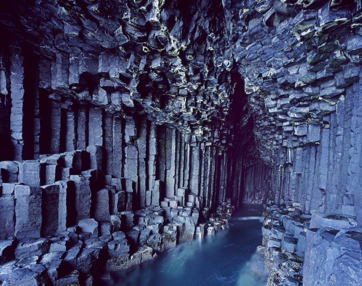 Fingal's Cave Scotland- Although this cave on Staffa Island looks like it was painstakingly hand-carved by someone with an affinity for hexagons, its incredible geometric structure is completely natural. Hot lava that helped form the cave cooled and cracked in a hexagonal pattern. As the cracks extended down the mass of lava and shrank, it created the columns that the cave is famous for today.