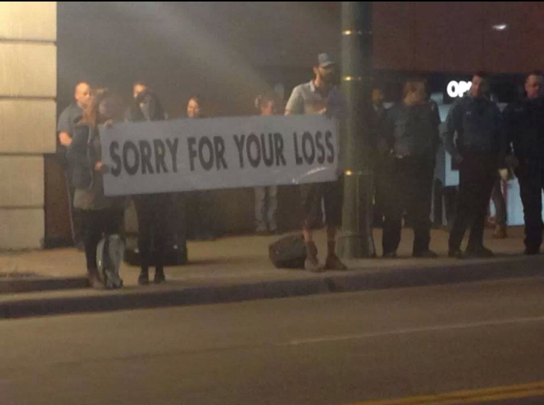 The Westboro Baptist Church was protesting outside the Lorde concert in KC, these guys are standing across from them.