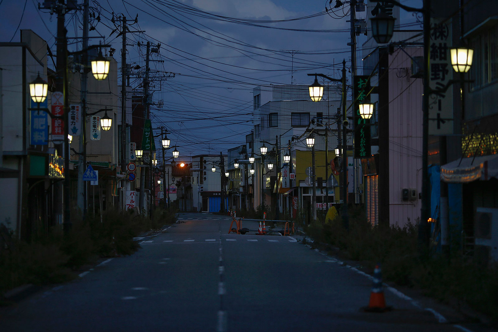 20,000 people used to live here, now it's a ghost town. This is Namie, Japan, now inside the nuclear Exclusion Zone created by the Fukushima disaster. The lights are left on to maintain hope of eventually returning to the town.