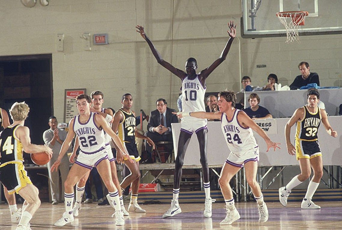 Manute Bol playing defense in 1984. At 7 ft 7 in tall, he was one of the tallest men ever to play in the National Basketball Association.