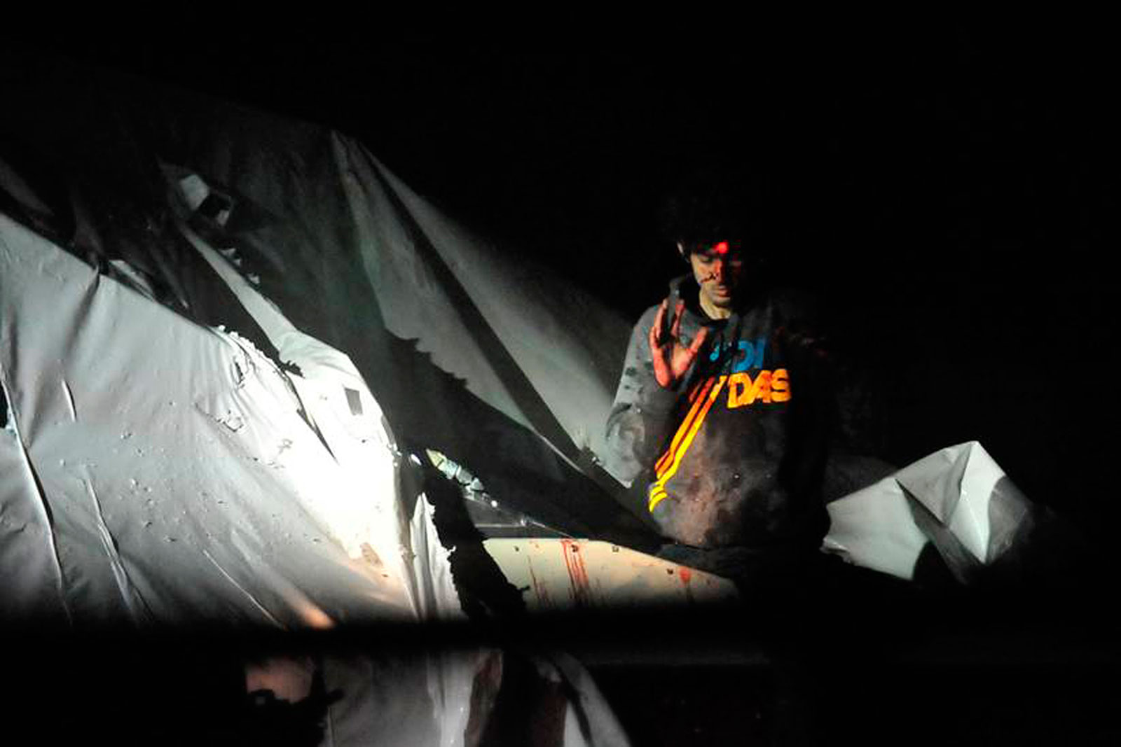 Dzhokar Tsarnaev, one of the brothers behind the Boston Marathon bombing, on the boat where he was eventually caught, with sniper lasers on his forehead. 2011