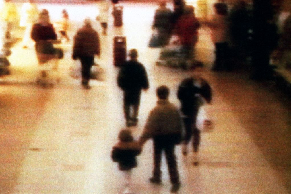 The toddler in the photo is James Bulger. He is being lead away from his mother by one of the two 10 year old boys who abducted and would later murder him. At the trial it was established that at this location, one of the boys threw blue Humbrol modelling paint, which they had shoplifted earlier, into Bulger's left eye. They kicked and stomped on him, and threw bricks and stones at him. Batteries were placed in Bulger's mouth. Police believed some batteries may have been inserted into his anus, although none were found there. Finally, a 22-pound, "10.0 kg" iron bar, described in court as a railway fishplate, was dropped on him. Bulger suffered ten skull fractures as a result of the iron bar striking his head. Dr. Alan Williams, the case's pathologist, stated that Bulger suffered so many injuries42 in totalthat none could be isolated as the fatal blow.