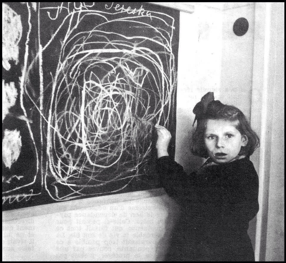 A girl who grew up in a concentration camp draws a picture of "Home" while living in a residence for disturbed children. Poland. 1948