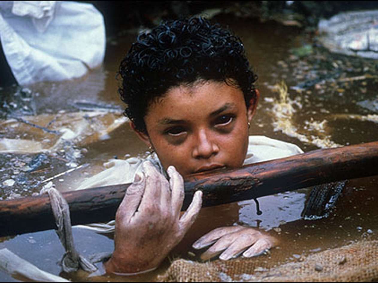 Omayra Sanchez Garzon was a Colombian girl killed in Armero, department of Tolima, by the 1985 eruption of the Nevado del Ruiz volcano, when she was 13 years old. Volcanic debris mixed with ice to form massive lahars, volcanically induced mudslides, landslides, and debris flows, that rushed into the river valleys below the mountain, killing nearly 25,000 people and destroying Armero and 13 other villages. After a lahar demolished her home, Sanchez became pinned beneath the debris of her house. She remained trapped in water for three days. Her plight was documented as she descended from calmness into agony. Her courage and dignity touched journalists and relief workers, who put great efforts into comforting her. After 55 hours of struggling, she died, likely as a result of either gangrene or hypothermia. Her death highlighted the failure of officials to respond promptly to the threat of the volcano, contrasted with the efforts of volunteer rescue workers to reach and treat trapped victims, despite a dearth of supplies and equipment.