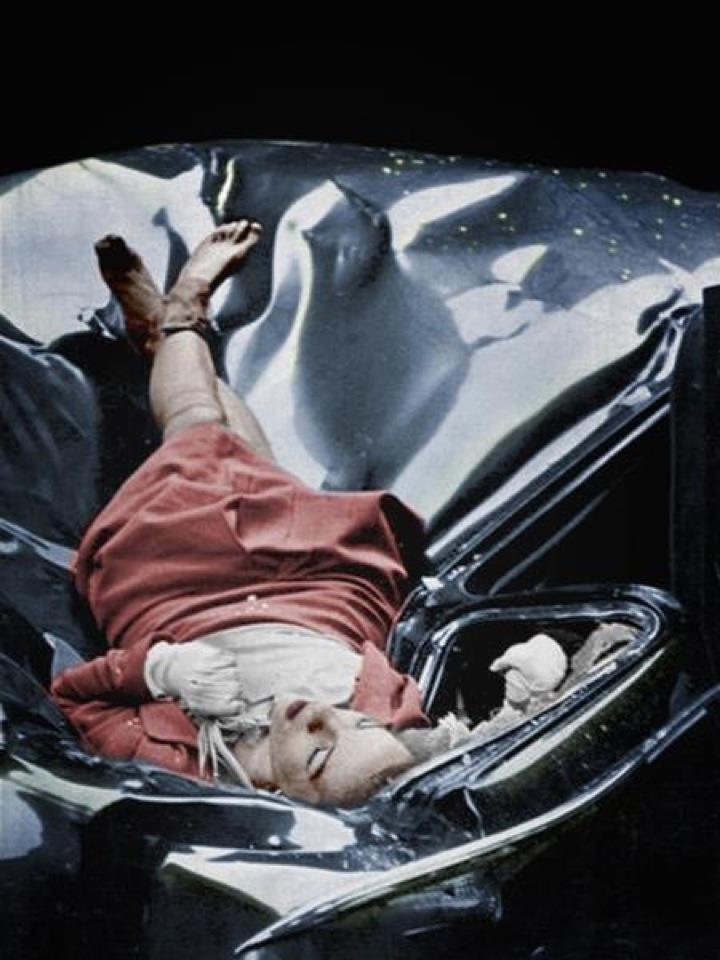 On May Day, just after leaving her fiance, 23-year-old Evelyn McHale wrote a note. "He is much better off without me  I wouldn't make a good wife for anybody." She went to the observation platform of the Empire State Building. Then she jumped. In her desperate determination, she leaped clear of the setbacks and hit a United Nations limousine parked at the curb. Across the street photography student Robert Wiles heard an explosive crash. Just four minutes after Evelyn McHale's death, Wiles got this picture of death's violence and its composure. The serenity of McHale's body amidst the crumpled wreckage it caused is astounding.
