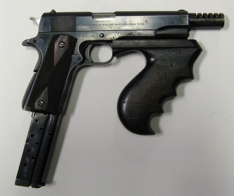 John Dillinger's 1911 converted to full auto and .38 Super, complete with a Thompson submachine gun forearm.