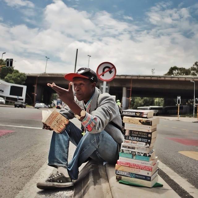 This young man sits on the side of Empire Road in South Africa and instead of begging he provides book reviews. He collects all these books, reads each of them, and provides reviews for people passing by. If you like the review, he will try to sell you the book. This is how he makes a living.