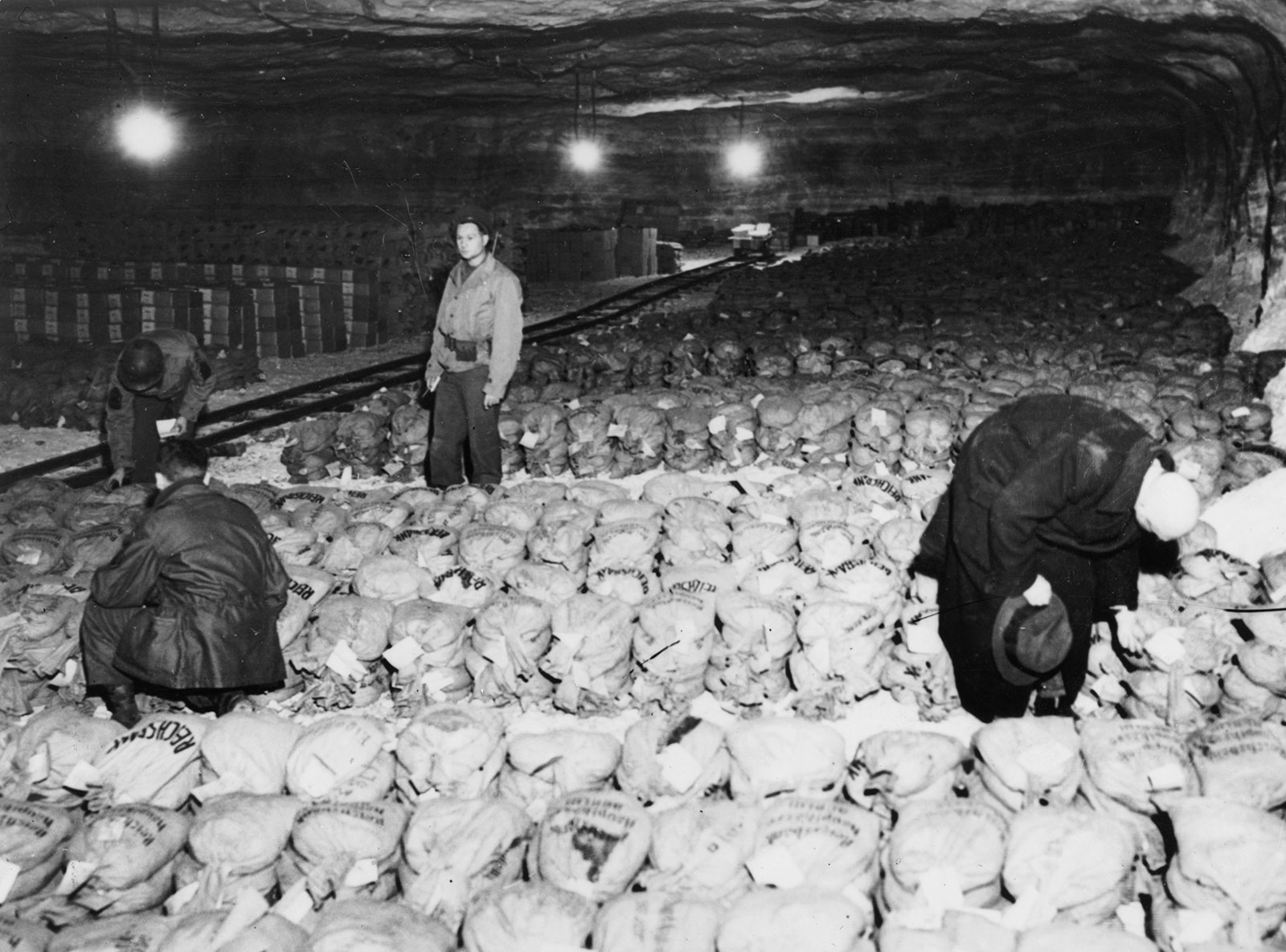 Members of General Patton's army with a stash of approximately 100 tons of gold bullion and art treasures found hidden in a salt mine near Merkers, Germany, 1945
