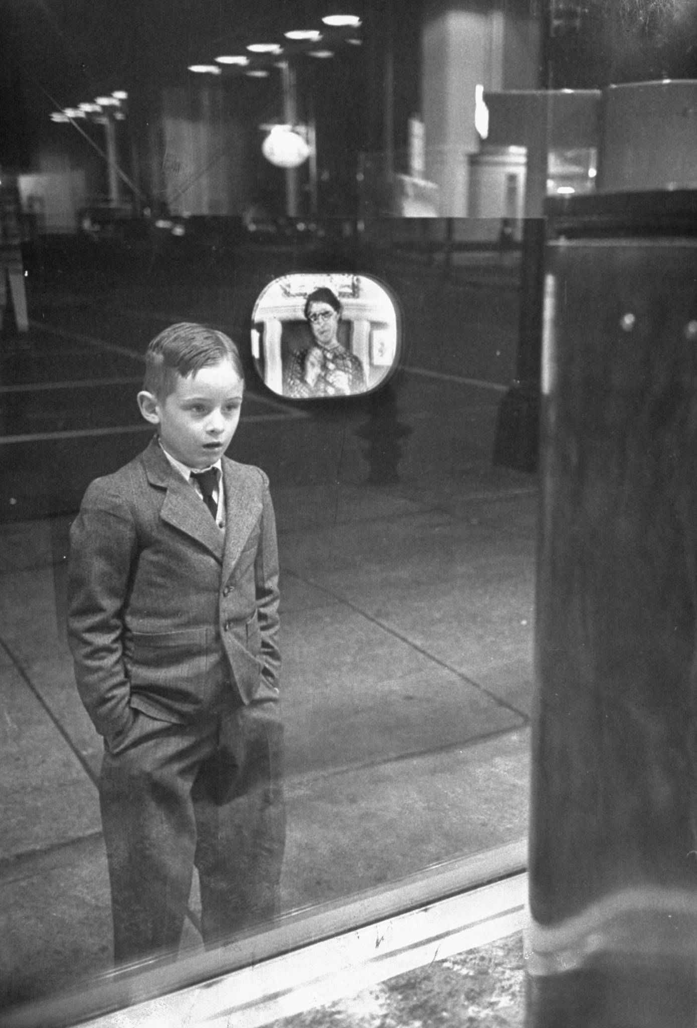 Boy watching TV for the first time in an appliance store window, 1948