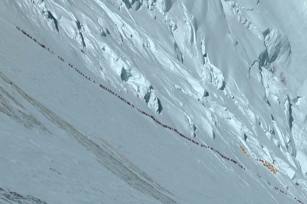 A crowd of climbers slog up the Lhotse Face, heading toward Camp IV, last stop before the summit. Loose regulations and a boom in commercial guiding over the past two decades have made Everest far more accessible to experts and novices alike.