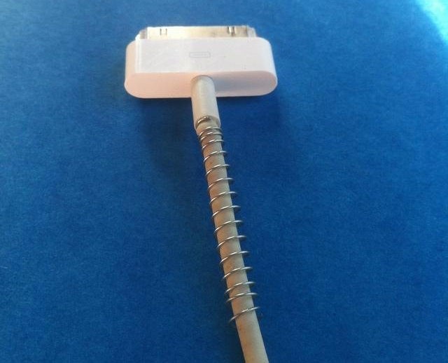 Use a spring from an old pen to protect chargers from bending and breaking.