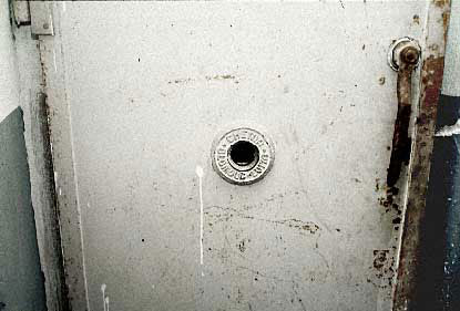 The "Judas Opening". A peephole in the door of the gas chamber, through which guards and V.I.P.s could enjoy watching the death agonies of their helpless, defenseless victims at Mauthausen.